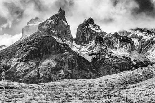 Hikers trail Paine Horns three granite peaks, Torres del Paine National Park, Patagonia, Chile