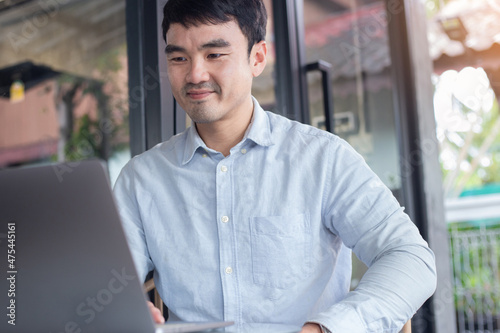 asian man work using computer hand typing laptop keyboard contact us.student study learning education online.adult professional people chatting search at office.concept for technology device business