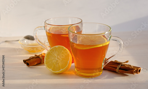 tea with lemon, cinnamon and honey, flat lay in warm colors