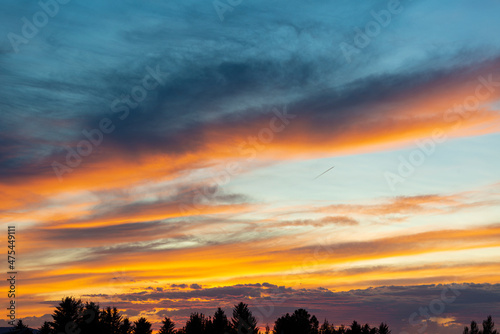 Fototapeta Naklejka Na Ścianę i Meble -  USA, Idaho. Backlit Cirrus Clouds and cloud bank on horizon make a magnificent sunset.