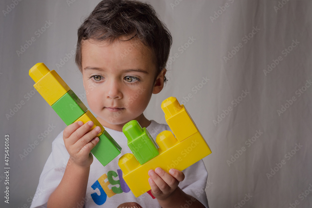 portrait of a little boy playing with building blocks portrait of a little boy playing with building blocks