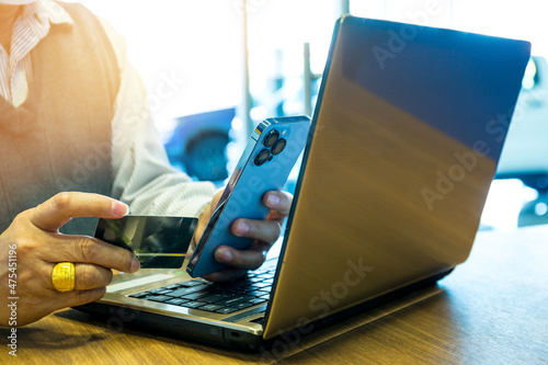Online banking businessman using smartphone with credit card and laptop Transfer money, business in office concept.. photo