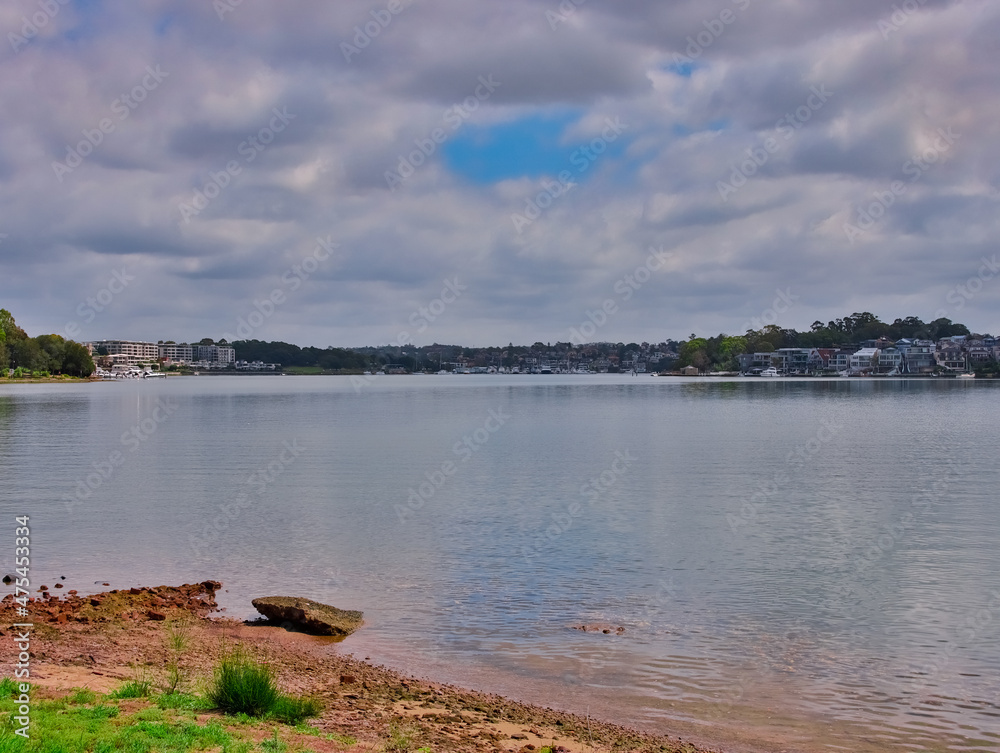 Panorama view of Concord Bay on Sydney Harbour NSW Australia, wealthy houses on the forshore nestled between lush green trees