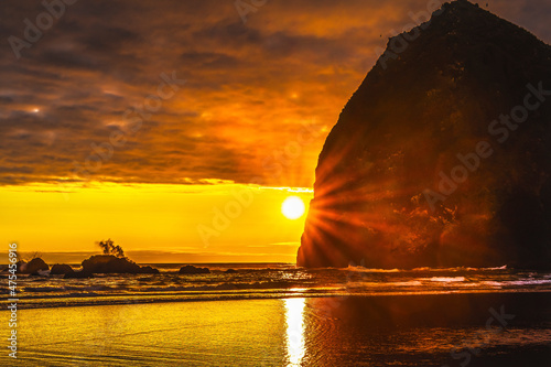 Colorful sunset, Haystack Rock sea stacks, Canon Beach, Clatsop County, Oregon. Originally discovered by Clark of Lewis Clark in 1805 photo