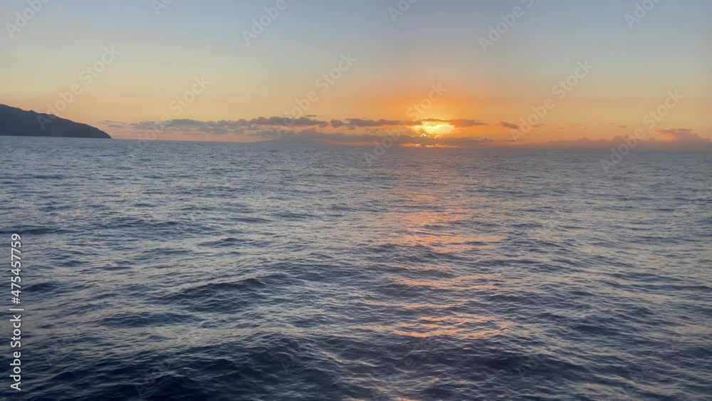 Orange sun setting over the sea seen from a cruise while navigation Orange sun setting over the sea seen from a cruise while navigation