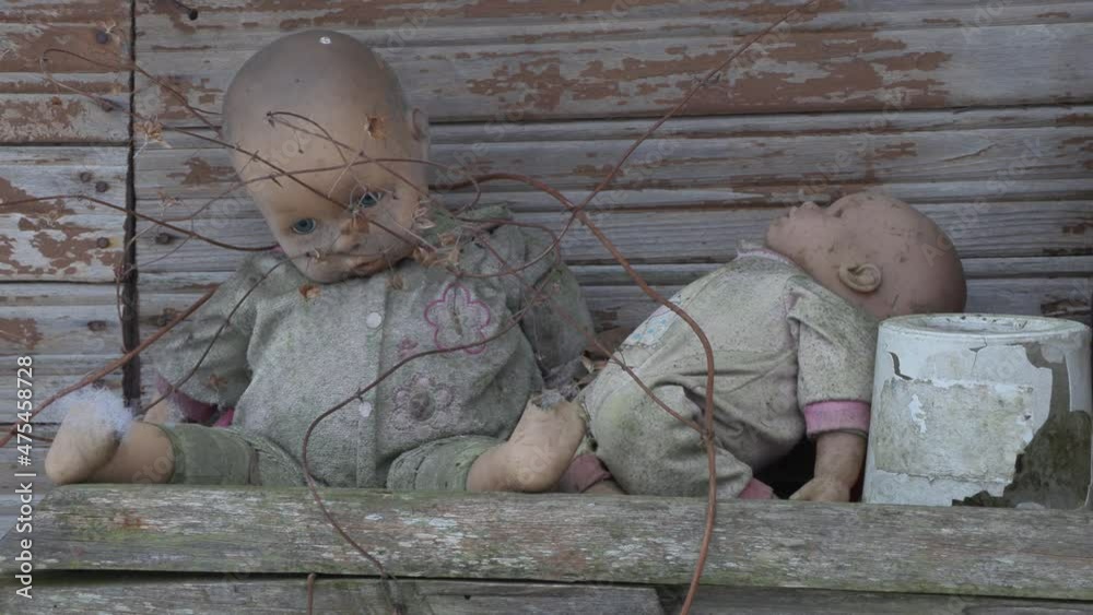 old dirty baby doll toy dangles in the wind