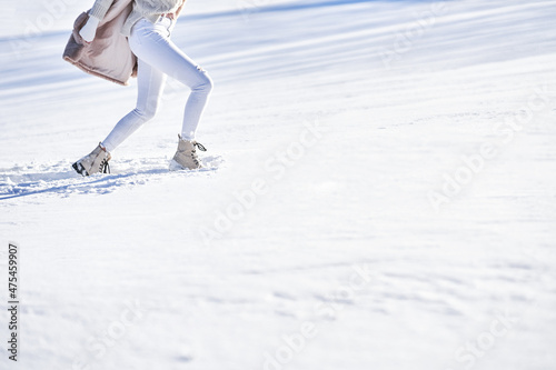 Woman walk on snow during winter season