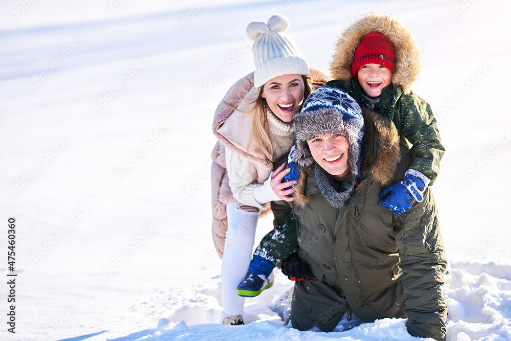 Nice happy family having fun on winter snow Nice happy family having fun on winter snow