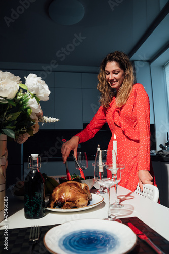 a woman housewife prepares a duck for a dinner in the kitchen