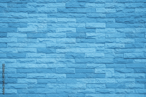 Brick wall painted with blue dark paint pastel calm tone texture background. Brickwork grid uneven bricks design stack backdrop.
