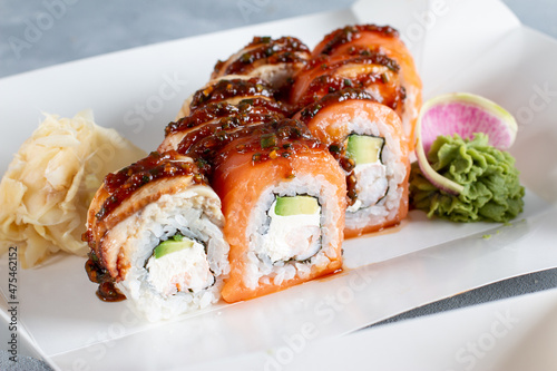 Sushi roll (Philadelphia) with salmon, smoked eel, cream cheese on light table. Sushi menu. Japanese food.