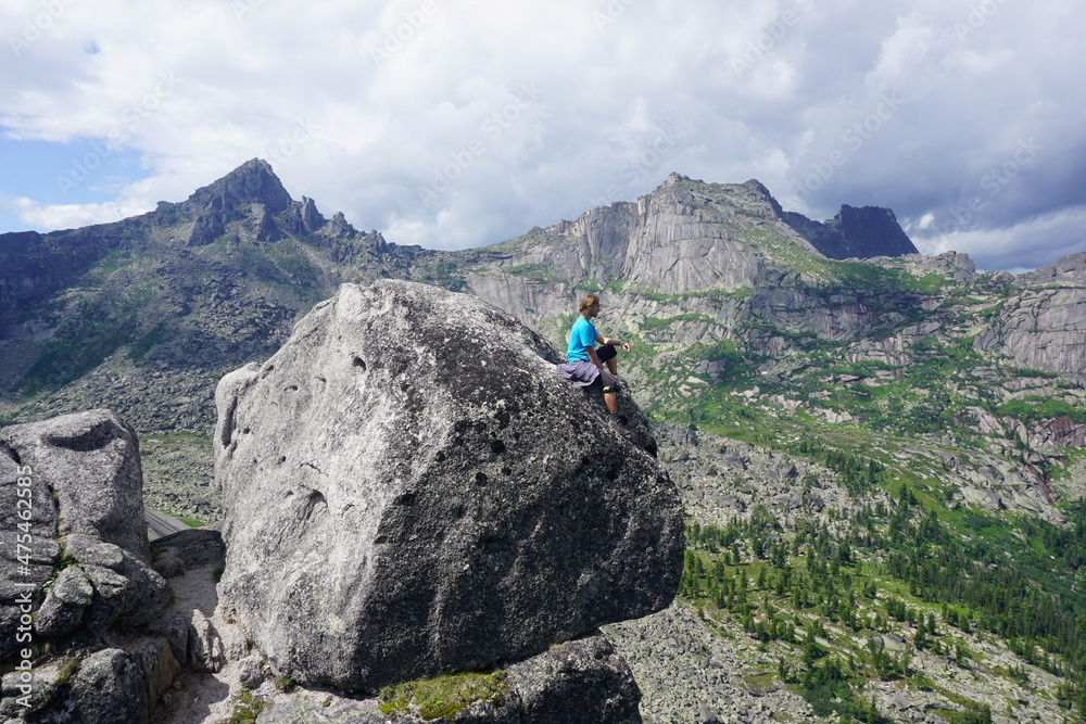 Hiker on top of a rock with a beautiful view of Ergaki natural practice