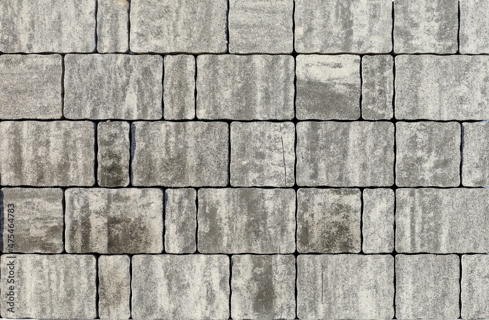 Fototapeta premium Snap lock tiles for exterior pavement made of gray granite mix. Background and texture
