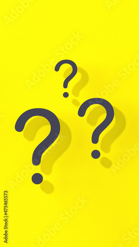 Question marks with shadow on yellow background. Technical support. Answers to questions. Vertical image. 3D image. 3D rendering.