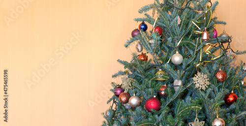 Decorated Christmas tree on orange background