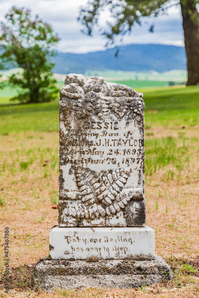 Farmington, Washington State, USA. Historical gravestone for a two year old girl from 1897 in an old cemetery in the Palouse hills.