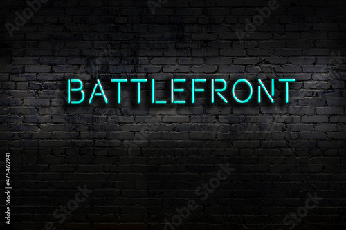 Night view of neon sign on brick wall with inscription battlefront Fototapet