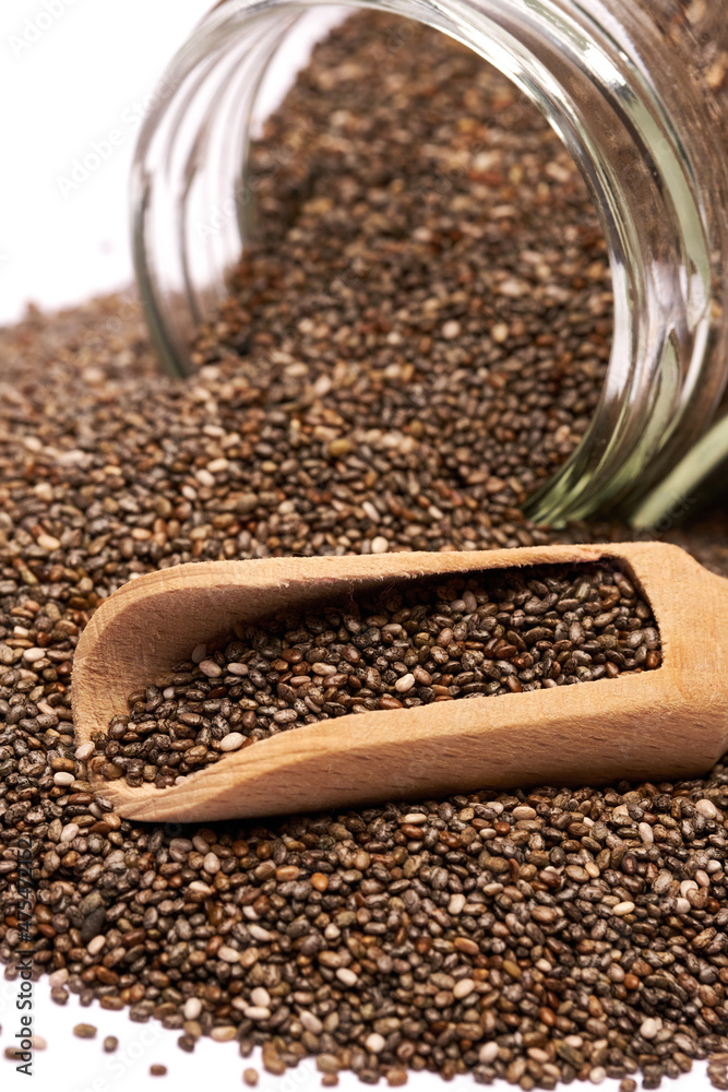 glass can full of organic natural chia seeds close-up isolated on white background glass can full of organic natural chia seeds close-up isolated on white background