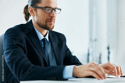 male manager with glasses works in an office or computer