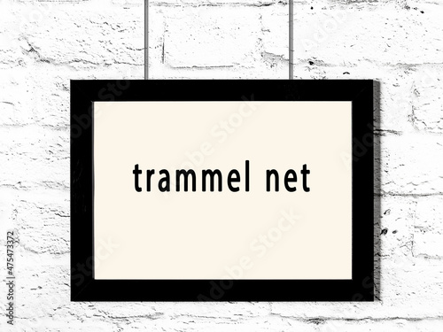 Obraz na plátně Black frame hanging on white brick wall with inscription trammel net