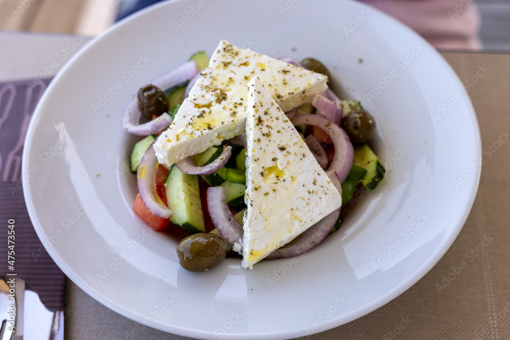 Greek salad with feta cheese. Typical delicious greek style lunch Greek salad with feta cheese. Typical delicious greek style lunch