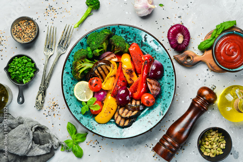 Food background. Barbecue. Grilled vegetables on a blue creative plate. Top view.