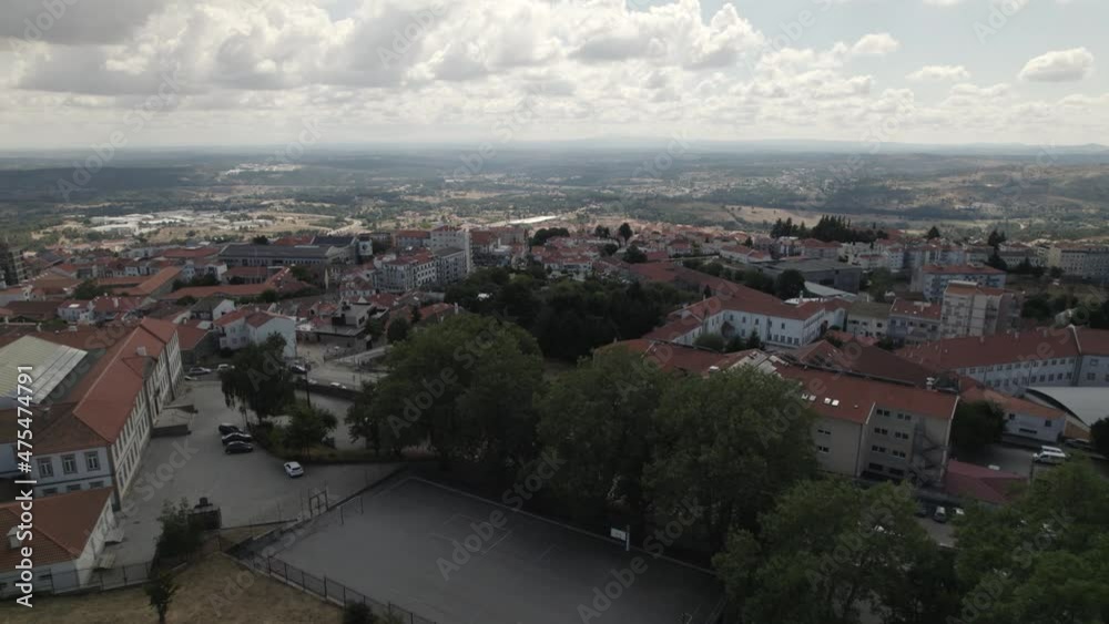 drone flight over the Tower of Castelo da Guarda, Guarda Castle, in Portugal, with rooftops and cityscape in background drone flight over the Tower of Castelo da Guarda, Guarda Castle, in Portugal, with rooftops and cityscape in background