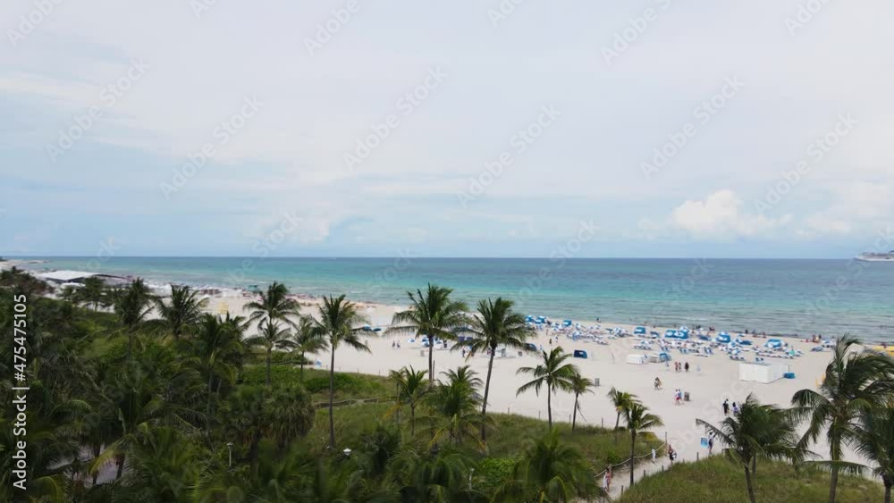 Miami Beach, Florida USA. Drone Aerial View of Waterfront and People on Sand on Cloudy Day Miami Beach, Florida USA. Drone Aerial View of Waterfront and People on Sand on Cloudy Day