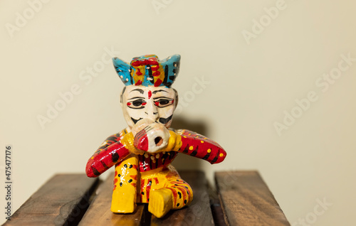 Handmade colorful wooden rajasthani musician souvenir with plain background.