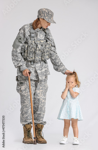 Female soldier with cane an...