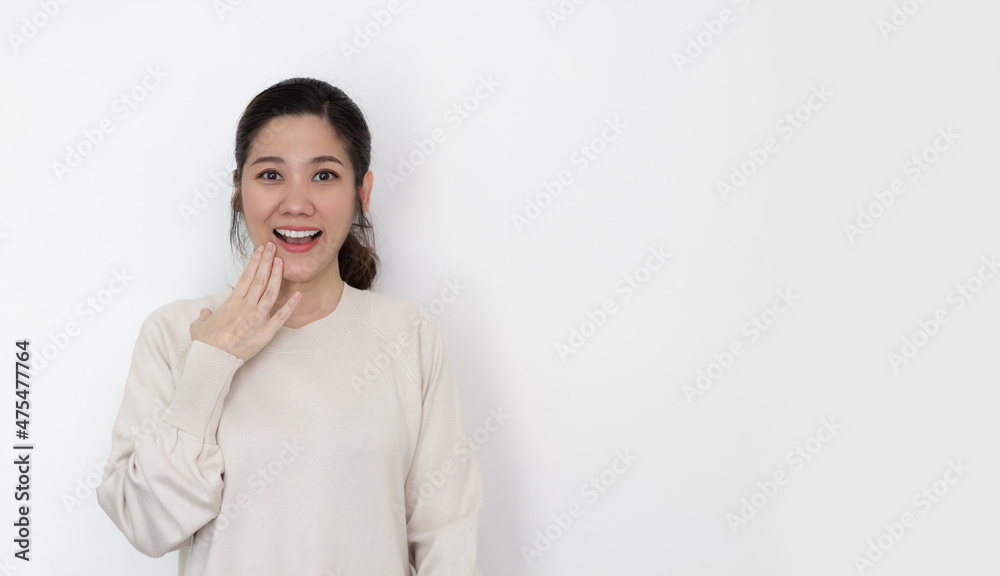 Asian women wear white t-shirt use hand touching her lip with surprised on news and promotion with copy space Asian women wear white t-shirt use hand touching her lip with surprised on news and promotion with copy space