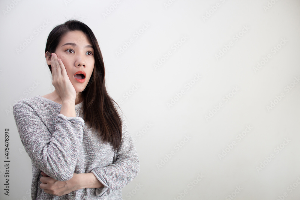 Asian beautiful woman are excited and surprised and using hand touching cheek and looking at space area. Asian beautiful woman are excited and surprised and using hand touching cheek and looking at space area.