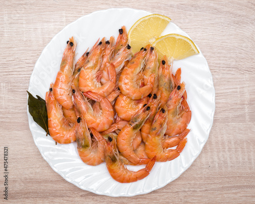 shrimp with lemon on a white plate