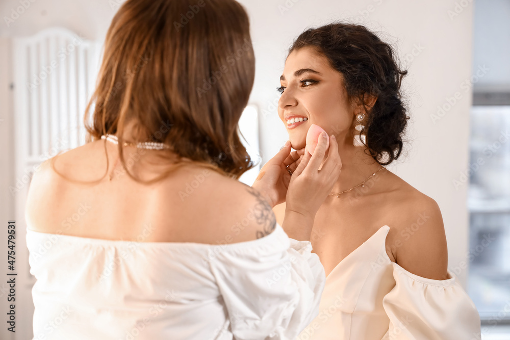 Makeup artist working with beautiful model in beauty salon Makeup artist working with beautiful model in beauty salon
