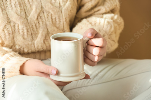 Woman holding cup of tea, closeup