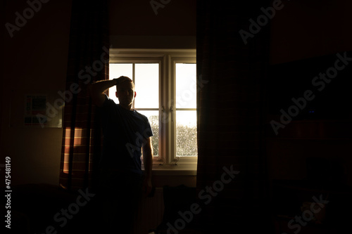 A man, middle-aged, adult, waits for the results of a covid-19 pcr test, self isolate, in a hotel room near Manchester airport, UK