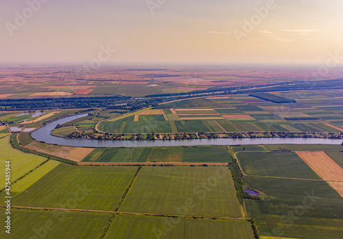 Birds-eye view of land and the Tisa river flowing through it in Serbia photo