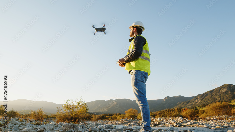 geologist with drone checks the territory - obrazy, fototapety, plakaty 