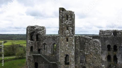 Llawhaden mediaeval castle ruins on hill, Wales in UK. Aerial pedestal up and reverse photo