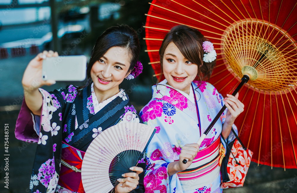 Storytelling image of two japanese girls wearing kimono spending time