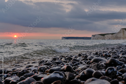 Sunset over the Seven Sisters chalk cliffs coastline, East Sussex. Low angle view.