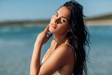 people, summer and swimwear concept - beautiful young woman in bikini swimsuit on beach
