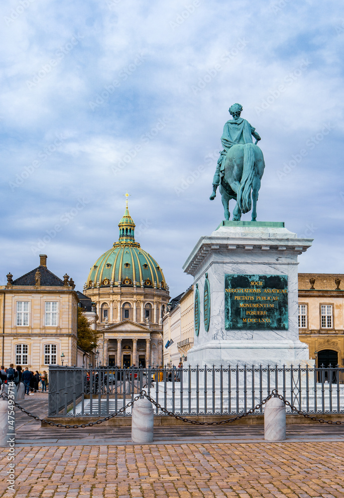 Copenhagen, Denmark - October 1, 2021: Amalienborg Palace, Frederick V Statue and Marble Church - Traslate: “The members of Asiatic business shall make known to the public, 1771”