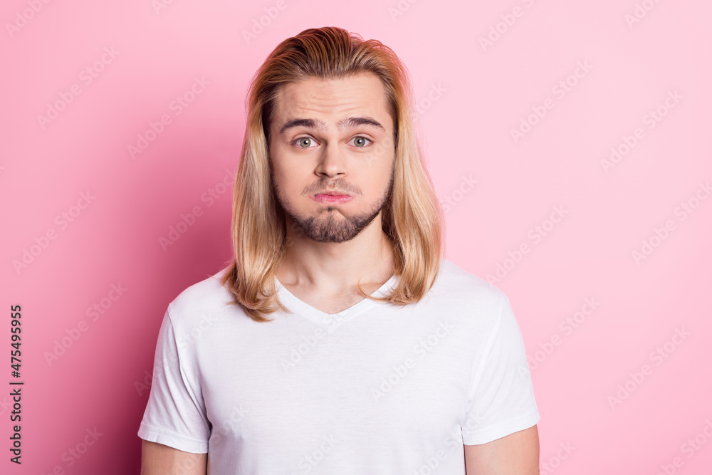 Photo of cute childish young guy wear white outfit bloated cheeks isolated pink color background Photo of cute childish young guy wear white outfit bloated cheeks isolated pink color background