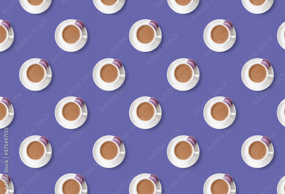 Pattern of coffee cups with lilac dessert cake macaroon on trendy very peri background Pattern of coffee cups with lilac dessert cake macaroon on trendy very peri background