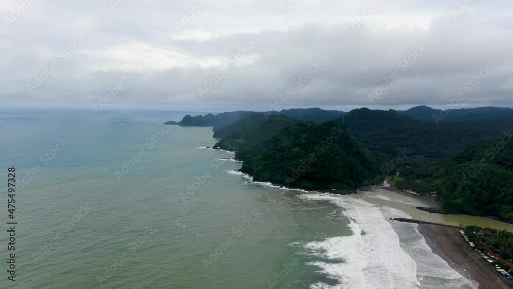 Air view of green hills and Suwuk beach in Kebumen, Indonesia. Aerial Air view of green hills and Suwuk beach in Kebumen, Indonesia. Aerial