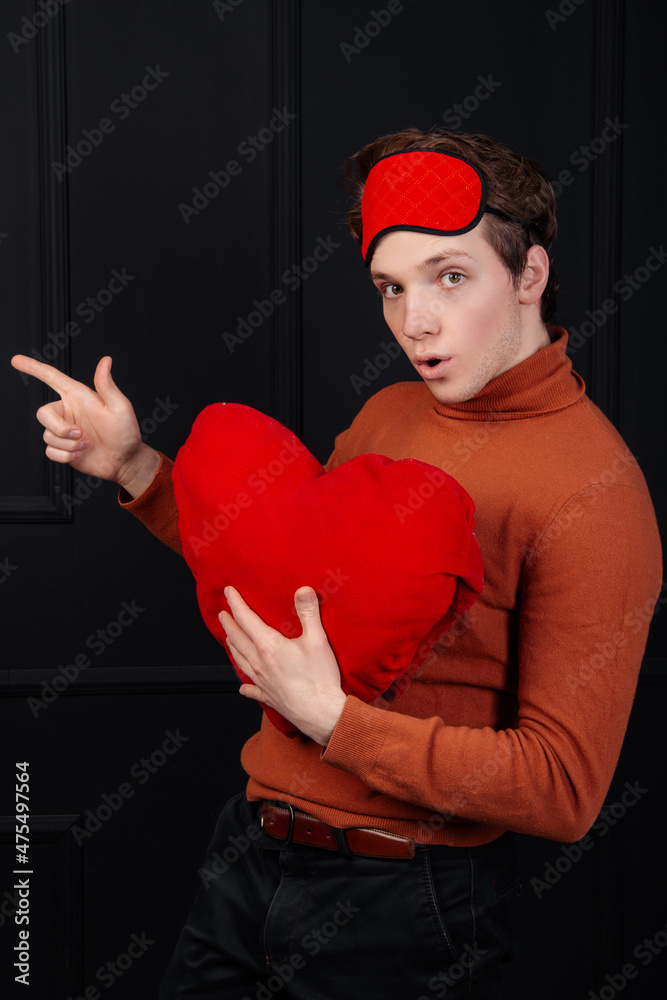 Handsome guy with a soft heart in his hands. Valentine's Day gifts. Handsome guy with a soft heart in his hands. Valentine's Day gifts.