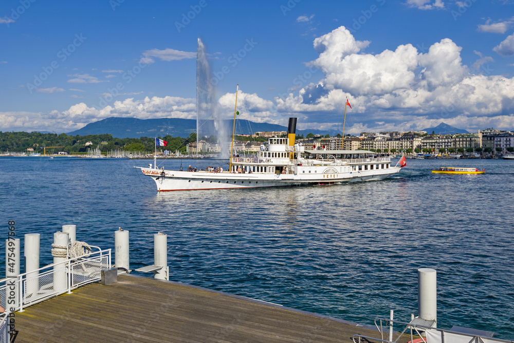 famous water jet and a vintage steamboat cruising on Lake Geneva, Geneva, Switzerland

 - obrazy, fototapety, plakaty 