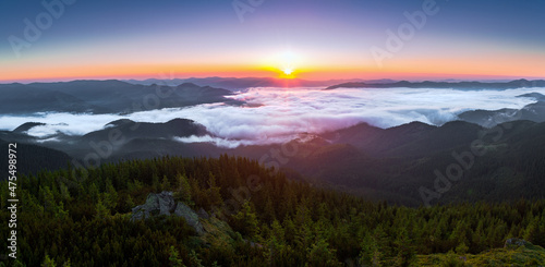Panorama with amazing sunrise. Landscape with high mountains. Fields and meadow are covered with morning fog and dew. Touristic resort Carpathian national park, Ukraine Europe. Natural scenery.