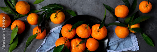 Fotografie Fresh raw tangerine on dark background, healthy food ingredients